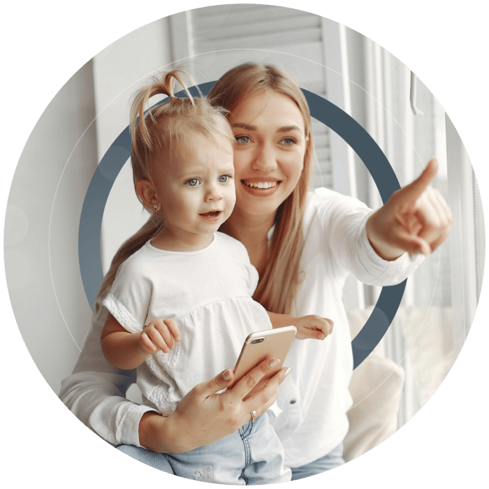Mother and young daughter using a phone together during a remote neurofeedback session